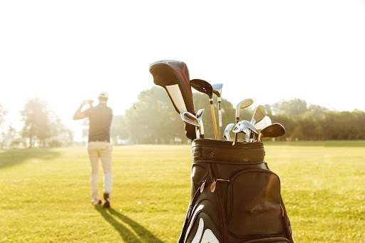 golf-bag-with-golf-player-hitting-on-fairway-in-the-background