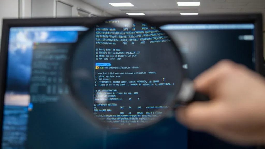 magnifying-glass-on-computer-screen-code