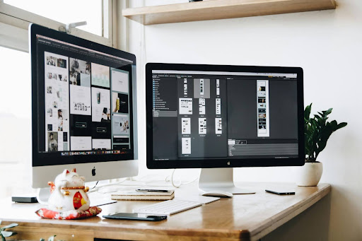 two-monitors-on-desk-with-natural-light-from-window