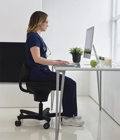 ergonomic-backless-chair-with-woman-sitting-at-desk