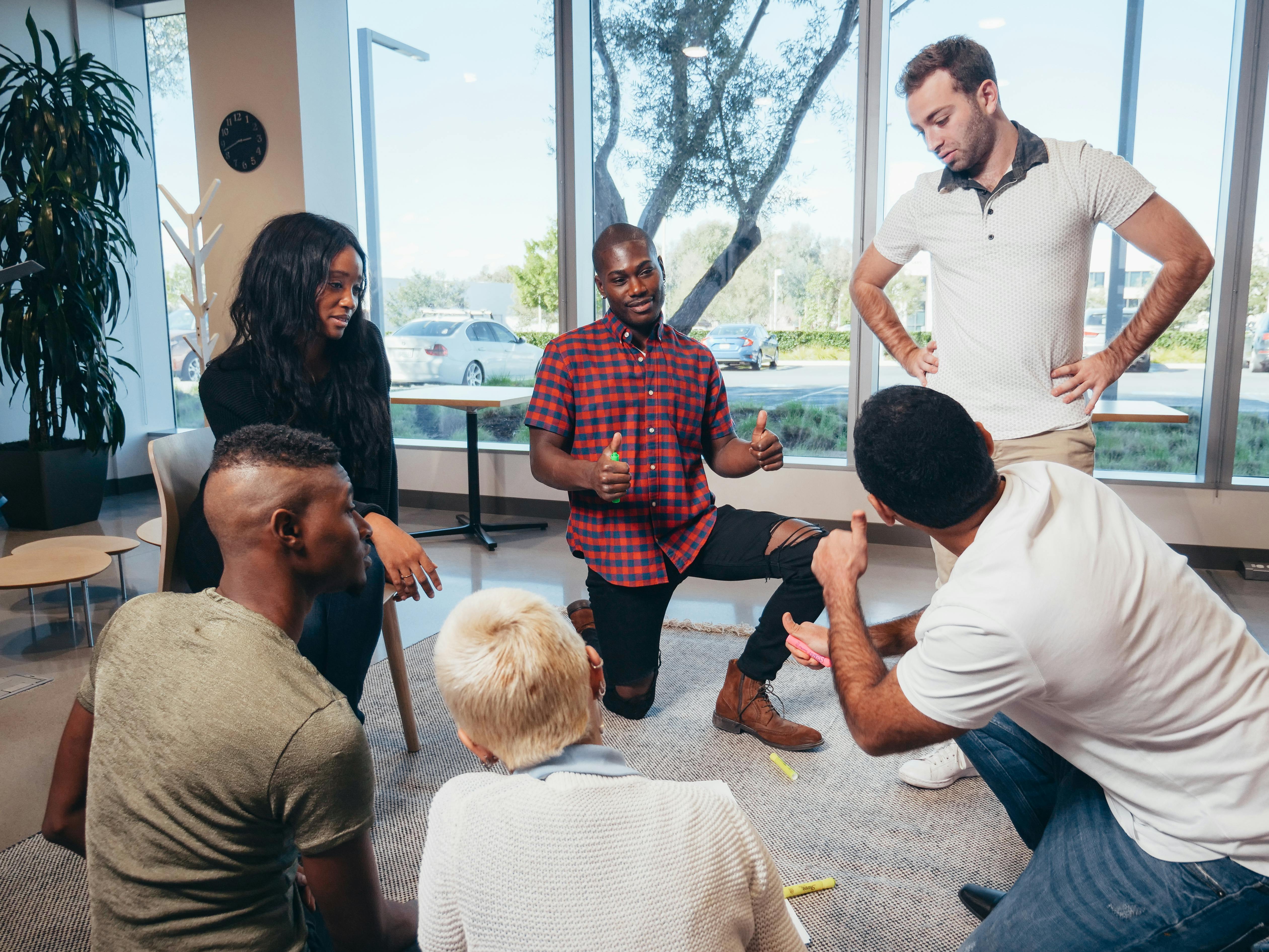 employees-having-discussion-in-circle-in-full-window-room