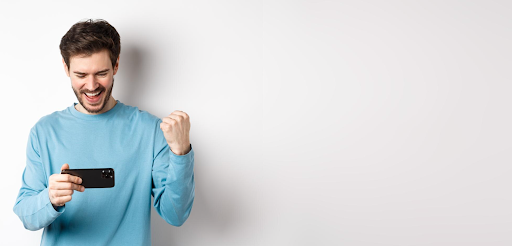 guy-holding-phone-who's-excited-about-something-on-his-phone